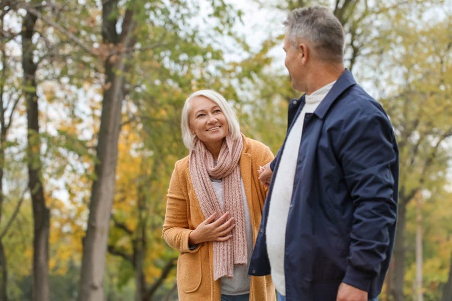 Residents walking together outdoors at a care setting